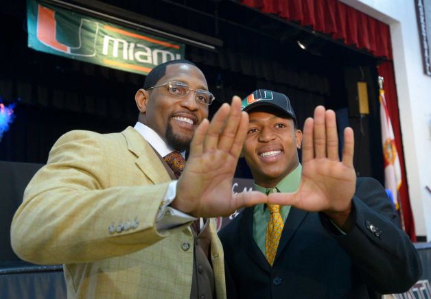 Ray Lewis III, right, and his father, former Baltimore Ravens linebacker Ray Lewis Jr., make the U sign with their hands, representing the University of Miami, after a national signing day ceremony in the Lake Mary Prep auditorium in Lake Mary, Fla., Wednesday, Feb. 6, 2013. Lewis III signed a letter of intent to play football at the University of Miami, where his father also played college football. (AP Photo/Phelan M. Ebenhack) Photo: Phelan M. Ebenhack, Associated Press / FR121174 AP