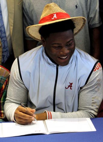 Reuben Foster signs a letter of intent to attend the University of Alabama and play college football during National Signing Day on Wednesday, Feb. 6, 2013, in Auburn, Ala. (AP Photo/Butch Dill) Photo: Butch Dill, Associated Press / FR111446 AP