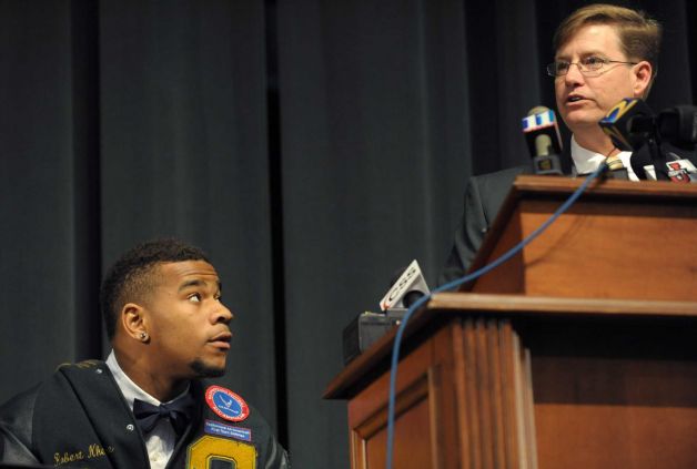 Grayson High School football player Robert Nkemdiche, left, the nation's top recruit, is introduced by Grayson High School head coach Mickey Conn as Nkemdiche announces his intent to play college football for Ole Miss during a signing day ceremony in Grayson, Ga., Wednesday Feb. 6, 2013. (AP Photo/David Tulis) Photo: Dave Tulis, Associated Press / FR170493 AP