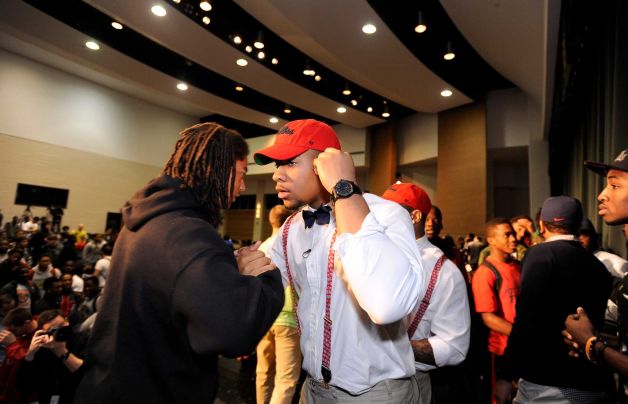 Grayson High School football player Robert Nkemdiche, the nation's top recruit, is congratulated by classmates after he announces his intent to play college football for Ole Miss, during a signing day ceremony at his high school auditorium in Grayson, Ga., Wednesday Feb. 6, 2013. (AP Photo/David Tulis) Photo: Dave Tulis, Associated Press / FR170493 AP