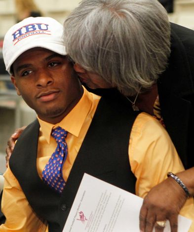 Hightower High School's Terrell Brown, gets a kiss from his grandmother, Sally Tarver, as he made his commitment to play football at Houston Baptist University during a signing day ceremony at the Buddy Hopson Field House Tuesday, Feb. 5, 2013, in Missouri City. Photo: Johnny Hanson, Houston Chronicle / © 2013  Houston Chronicle
