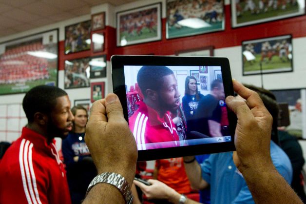 Nebraska signee Adam Taylor is photographed on an iPad by his father, Barry, during a National Letter of Intent signing ceremony at Katy High School Wednesday, Feb. 6, 2013, in Katy. Photo: Brett Coomer, Houston Chronicle / © 2013 Houston Chronicle