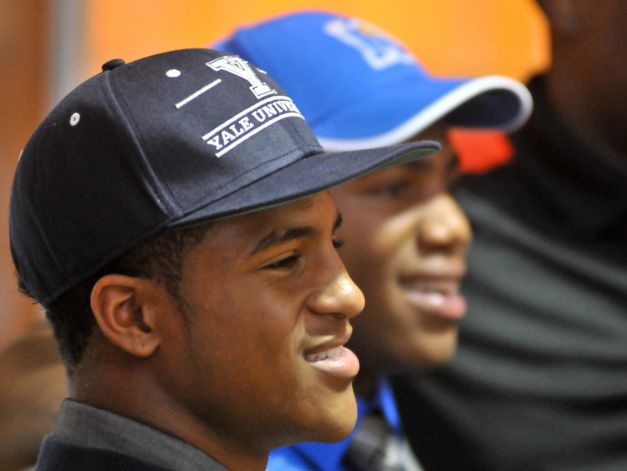 Madison High School football players Galen McAllister (left) and Marquis Warford smile during National Signing Day Wednesday. McAllister will play Yale and Warford will play at the University of Memphis. Photo: Robin Jerstad