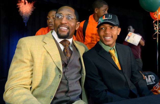 Ray Lewis III, right, poses for photos with his father, former Baltimore Ravens linebacker Ray Lewis Jr., during a national signing day ceremony in the Lake Mary Prep auditorium in Lake Mary, Fla., Wednesday, Feb. 6, 2013. Lewis signed a letter of intent to play football at the University of Miami, where his father also played college football. (AP Photo/Phelan M. Ebenhack) Photo: Phelan M. Ebenhack, Associated Press / FR121174 AP