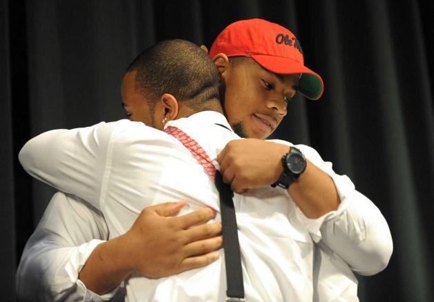 Grayson High School football player Robert Nkemdiche, right, the nation's top recruit, is congratulated by his brother Denzel during Nkemdiche's announcement to play college football for Ole Miss, at a Grayson, Ga., signing ceremony Wednesday Feb. 6, 2013. Denzel Nkemdiche also plays for the Rebels. (AP Photo/David Tulis) Photo: Dave Tulis, Associated Press / FR170493 AP