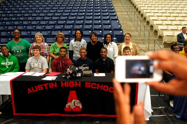Austin High School students who committed to play football in college get their picture taken with their mothers during a signing day ceremony at the Buddy Hopson Field House Tuesday, Feb. 5, 2013, in Missouri City. Photo: Johnny Hanson, Houston Chronicle / © 2013  Houston Chronicle