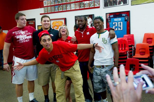 New Mexico signee Isaiah Brown, center, jumps in front of a photo of his teammates during a National Letter of Intent signing ceremony at Katy High School Wednesday, Feb. 6, 2013, in Katy. Photo: Brett Coomer, Houston Chronicle / © 2013 Houston Chronicle