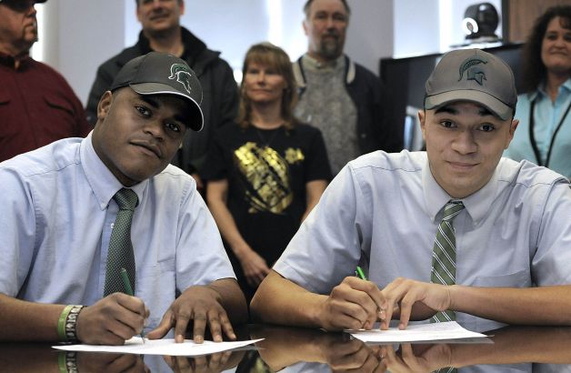 Cathedral Preparatory School seniors Delton Williams, left, and Damion Terry, attend a ceremonial letter-of-intent signing at the school in Erie, Pa., on Wednesday, Feb. 6, 2013. Earlier in the day, they signed their actual letters of intent to attend and play football at Michigan State. (AP Photo/Erie Times-News, Christopher Millette) MAGS OUT, TV OUT Photo: Christopher Millette, Associated Press / Erie Times-News