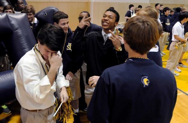 Saint James' CJ Duncan (center) talks to teammates before signing a letter of intent to attend and play football for Vanderbilt, Wednesday, Feb. 6, 2013, at the high school in Montgomery, Ala. (AP Photo/Montgomery Advertiser, Amanda Sowards) NO SALES Photo: Amanda Sowards, Associated Press / Montgomery Advertiser