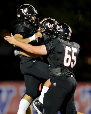 Churchill's Nicholas Smisek (left) is congratulated by Robert O'Hare (88) and Michael Cameron (65) after Smisek scored a touchdown during a district 26-5A football game between the Roosevelt Rough Riders and the Churchill Chargers at Comalander Stadium in San Antonio, Saturday, October 27, 2012. John Albright / Special to the Express-News. Photo: JOHN ALBRIGHT, Express-News / San Antonio Express-News
