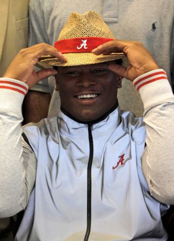 Reuben Foster dons an Alabama hat as he announces his intentions to attend the university and play college football during National Signing Day on Wednesday, Feb. 6, 2013, in Auburn, Ala. (AP Photo/Butch Dill) Photo: Butch Dill, Associated Press / FR111446 AP