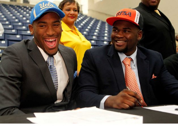 Fort Bend Marshall linebacker Deon Hollins Jr., left, who committed to play football at UCLA, shares a laugh with teammate Anthony Lee who committed to the University of Texas San Antonio during a signing day ceremony at the Buddy Hopson Field House Tuesday, Feb. 5, 2013, in Missouri City. Photo: Johnny Hanson, Houston Chronicle / © 2013  Houston Chronicle