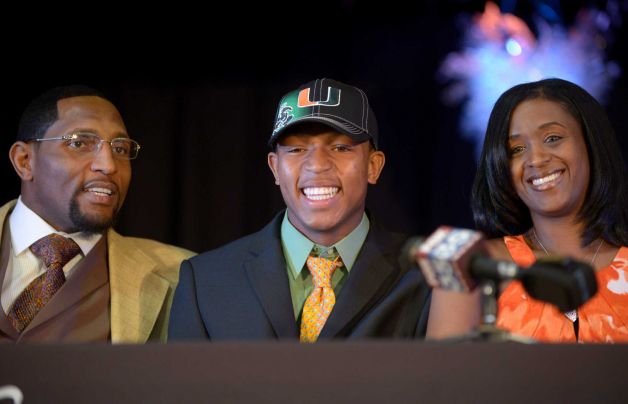 Ray Lewis III, center, poses for photos with his father, former Baltimore Ravens linebacker Ray Lewis Jr., left, and mother, Tatyana McCall, during a national signing day ceremony in the Lake Mary Prep auditorium in Lake Mary, Fla., Wednesday, Feb. 6, 2013. Lewis signed a letter of intent to play football at the University of Miami, where his father also played college football. (AP Photo/Phelan M. Ebenhack) Photo: Phelan M. Ebenhack, Associated Press / FR121174 AP