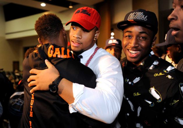 Grayson High School football player Robert Nkemdiche, center, the nation's top recruit, is congratulated by classmates after his announcement to play college football for Ole Miss, during a Grayson, Ga., signing ceremony Wednesday Feb. 6, 2013. (AP Photo/David Tulis) Photo: Dave Tulis, Associated Press / FR170493 AP