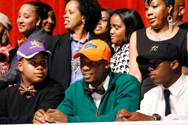 Wide receiver Marqui Hawkins, center, sits with Carver High School teammates John Thomas, left, and Dany Ryles, right, during Signing Day events at the school auditorium in Columbus, Ga., Wednesday, Feb 6, 2013. Hawkins signed his letter of intent with Florida, Thomas with Miles College and Ryles with West Georgia Technical College. (AP Photo/The Ledger-Enquirer, Robin Trimarchi) Photo: Robin Trimarchi, Associated Press / The Ledger-Enquirer