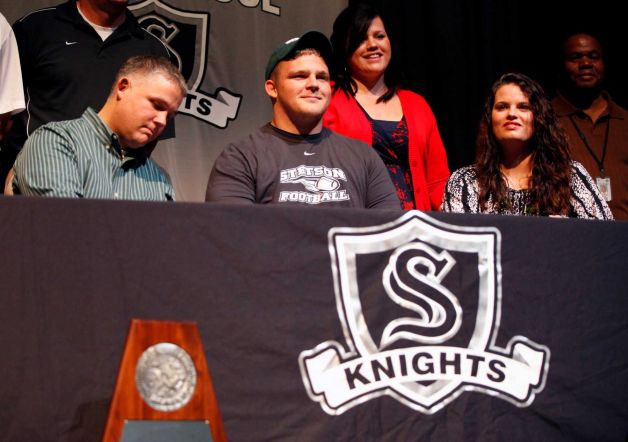 Steele High School  football player Cory Staud ,wearing hat, smiles Wednesday Feb. 6, 2013 after signing a letter of intent on National Signing Day to play football at Stetson University. Photo: William Luther, San Antonio Express-News / © 2013 San Antonio Express-News