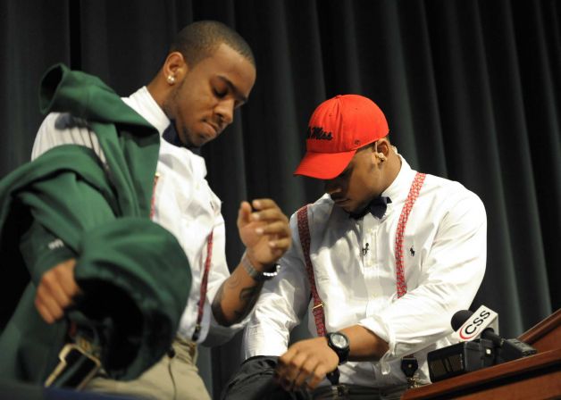 Grayson High School football player Robert Nkemdiche, right, the nation's top recruit, and his brother Denzel unveil their red suspenders during Nkemdiche's announcement to play college football for Ole Miss, at a Grayson, Ga., signing ceremony Wednesday, Feb. 6, 2013. (AP Photo/David Tulis) Photo: Dave Tulis, Associated Press / FR170493 AP