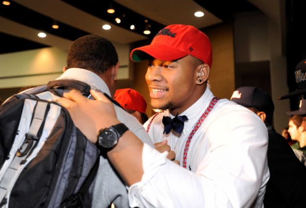 Grayson High School football player Robert Nkemdiche, the nation's top recruit, is congratulated by teammates after he announces his intent to play college football for Ole Miss, during a signing day ceremony at his high school auditorium in Grayson, Ga., Wednesday Feb. 6, 2013. (AP Photo/David Tulis) Photo: Dave Tulis, Associated Press / FR170493 AP