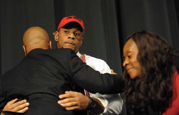 The nation's top recruit, Grayson High School's Robert Nkemdiche, center, hugs his father Sunday, left, and mother Beverly after announcing his intent to play college football for Ole Miss, during a signing day ceremony at his high school auditorium in Grayson, Ga., Wednesday Feb. 6, 2013. (AP Photo/David Tulis) Photo: Dave Tulis, Associated Press / FR170493 AP