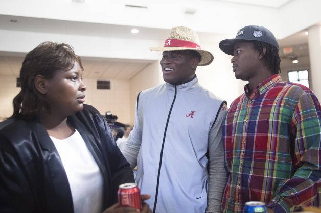 Rueben Foster, center, talks to his brother Danny Foster after announcing his intentions to attend the University of Alabama and play college football during National Signing Day on Wednesday, Feb. 6, 2013, in Auburn, Ala.  (AP Photo/Opelika-Auburn News, Albert Cesare) Photo: Albert Cesare, Associated Press / Opelika-Auburn News