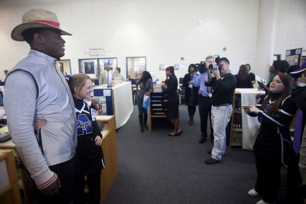 An uburn High School cheerleader takes her photo with Reuben Foster after after announcing his intentions to attend the University of Alabama and play college football during National Signing Day on Wednesday, Feb. 6, 2013, in Auburn, Ala.  (AP Photo/Opelika-Auburn News, Albert Cesare) Photo: Albert Cesare, Associated Press / Opelika-Auburn News