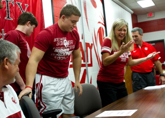 Oklahoma signee Matt Dimon, pulls out a chair for his mother, Cindi Dimon, during a National Letter of Intent signing ceremony at Katy High School Wednesday, Feb. 6, 2013, in Katy. Photo: Brett Coomer, Houston Chronicle / © 2013 Houston Chronicle