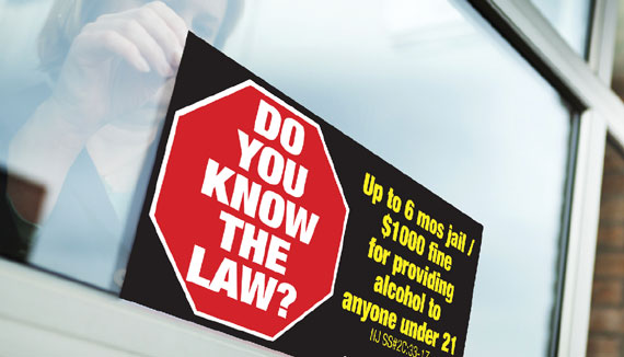 Photo of an advertisement posted in a liquor store window as part of the 'Know the Law' campaign.