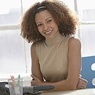 Woman smiling at desk.