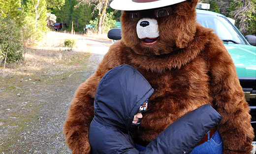 Smokey Bear receives a bear hug from a child visiting Sims Flat Campground in the Shasta Trinity National Forest in Redding, California. (Photo credit: U.S. Forest Service, Paul Young)