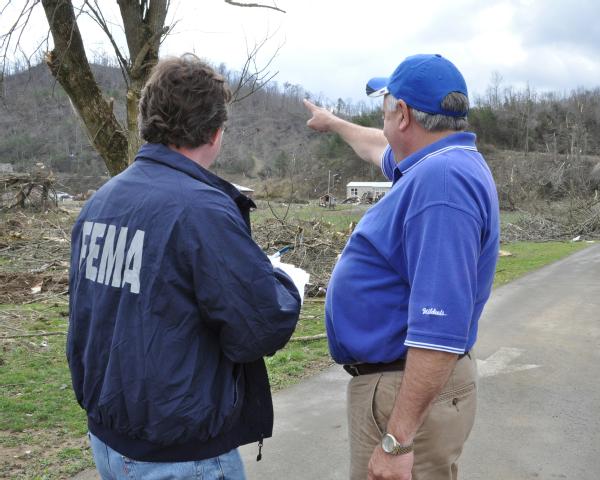 Denver, Ky., March 13, 2012 -- Sam Auxier, Manager of Johnson County Roads and Field Operations, points out to Public Assistance Inspector Emmett Wainwright, the path taken by the tornado. FEMA makes funds available to help counties rebuild roads and remove storm related debris. Photo by Marilee Caliendo/FEMA.