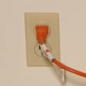Orange extension plugged in to the wall