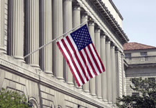 Commerce building exterior with U.S. flag.