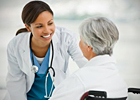 Doctor talking to female patient in wheelchair