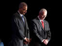 Attorney General Holder and Director Clark showing respect during the invocation.