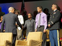 Attorney General Holder greets a military family in attendence. 'Supporting these families – as well as the many children across our country who need and deserve our help – is far more than our professional obligation. It is our moral calling.  How we meet this challenge will define this nation, and determine its progress, for decades to come.'
