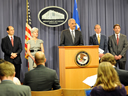 Attorney General Eric Holder stands with Dr. Peter Budetti, Deputy Administrator for Program Integrity of CMS, FBI Deputy Director Sean Joyce, Department of Health and Human Services Secretary Kathleen Sebelius, Assistant Attorney General Lanny A. Breuer of the Criminal Division and HHS Deputy Inspector General Gary Cantrell to announce a nationwide takedown by Medicare Fraud Strike Force operations in seven cities.