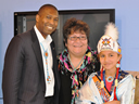 From left, Acting Associate Attorney General Tony West and Geri Small, Director of the Boys & Girls Club, Northern Cheyenne Nation with one of the Club's youth, dressed in traditional clothing. The facility provides a safe haven for at-risk youth, offers prevention programs to cut drop-out rates, teen pregnancy, and youth incarceration, and nurtures boys and girls with cultural activities that also keep Northern Cheyenne culture alive.