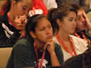A participant listens during a question and answer period where issues such as drugs, sexual assault, gangs and violence, were discussed.