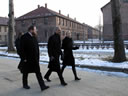 Attorney General Holder, accompanied by the Auschwitz-Birkenau Memorial and State Museum Director Piotr Cywinski, tours the barracks area of the Auschwitz I concentration camp.