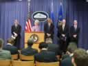 Health and Human Services Secretary Kathleen Sebelius at the podium addressing reporters. Behind the Secretary from left to right are Assistant Attorney General Lanny A. Breuer of the Criminal Division; Attorney General Eric Holder; FBI Executive Assistant Director Shawn Henry; and Health and Human Services Inspector General Daniel R. Levinson.