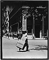 Thumbnail for: No caption. Boy delivering packages., 