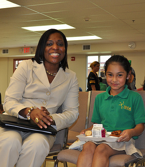 USDA employee DeAdrian Maddox poses with girl during kick-off ceremony