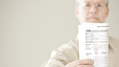 Man holds 1040 U.S. tax form-2012 Tax Tips for People Over 50