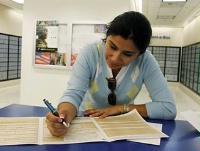 Date: 05/18/2009 Description: Yolanda Limon fills a form for her daughter to request a U.S. passport at a post office in Los Angeles. © AP Image