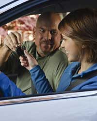 Photo: A father handing the car keys to his daughter.