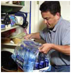 Man lifting a case of bottled water