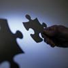The image of hands holding puzzle pieces shadow