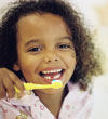 Girl with a pea sized amount of toothpaste on her toothbrush