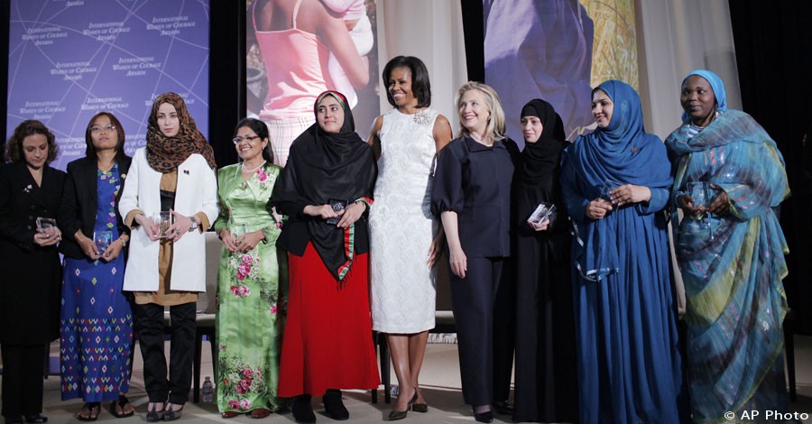 Secretary of State Hillary Rodham Clinton and First Lady Michelle Obama pose for a photo with the recipients of the 2012 International Women of Courage Award, on the 101st Anniversary of International Women's Day, March 8, 2012, at the State Department in Washington. [AP File Photo]