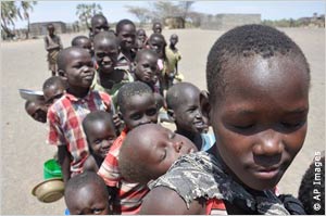 Children line up for a feeding program in Kenya. More than 13 million people in the region need food aid, according to the U.N., a disproportionate number of them children.
